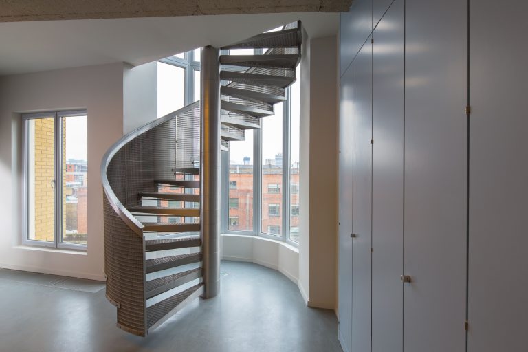 A metal spiral staircase in a refurbished building