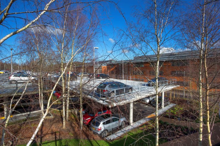 Aerial view of a dual storey car park with upper concrete decking
